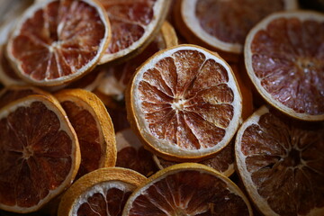 Close-up of dried orange slices in bamboo basket. Natural citrus fruit preserved for herbal tea,...