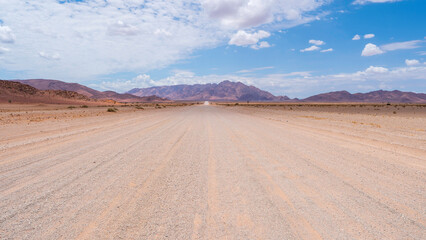 Driving through the desertic endless roads in Central-West Namibia near Solitaire