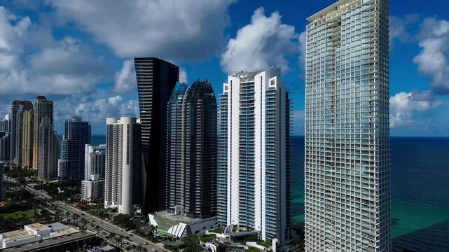 Aerial view of North Miami Beach Collins Avenue highrise buildings and ocean looking north in 4k