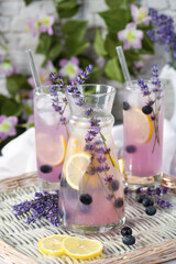 Summer lemonade with lavender, lemon juice, lavender syrup and blueberries in a pitcher