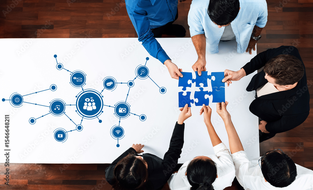 Poster Aerial view of diverse individuals collaborating on a puzzle, symbolizing teamwork and media integration in a modern workspace filled with connectivity icons. Amity