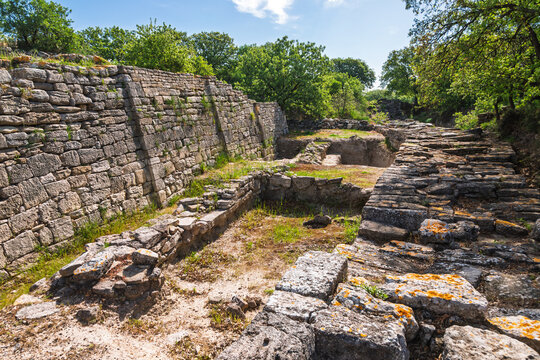 Eastern gate and defensive wall of Troy VI in Сanakkale Turkey with monumental stone masonry and excavated entrance pathway