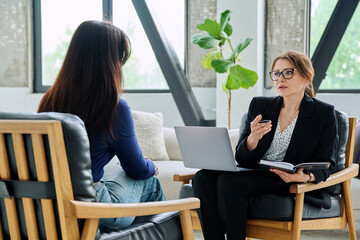 Female mental health professional working with young woman
