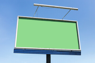 Empty billboard with green screen. Blank advertising banner on metal frame. Outdoor mockup display for marketing. Sky background with clouds. Copy space for design. Urban commercial message area.
