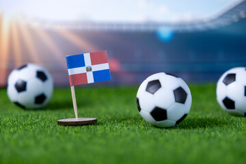 Dominican Republic flag, with soccer balls on green grass, symbolizing national team pride, athletic spirit, and international competition