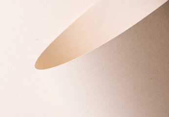 Curved sheet of elegant designer paper in creamy beige tones with tactile porous texture and organic
