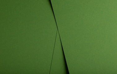 Designer paper background in green. Matte and smooth surface with fiber texture, geometric overlap
