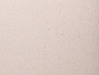 Flat sheet of designer paper in warm beige and cream tones with soft grainy texture and organic