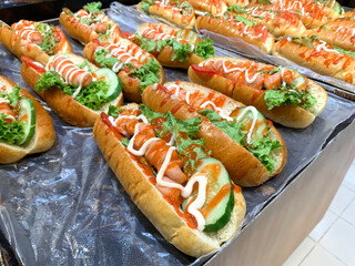Freshly Made Hot Dogs with Vegetables and Sauce on Display