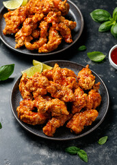Korean fried chicken with spicy sauce and sesame seeds