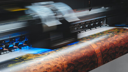 Printer is printing a colorful image image is vibrant and lively, with a mix of blues, greens, and...