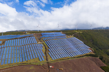 Clean Energy Transition with solar panels and wind turbines on Madeira island. Aerial view