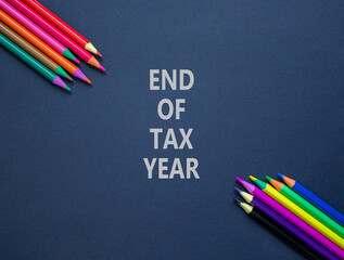 End of tax year symbol. Concept words phrase End of tax year on beautiful black paper. Colored...