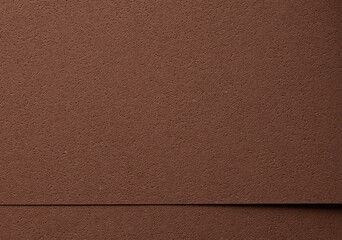 Luxury background with overlapping sheets of designer paper in rich chocolate brown tones. Pitted