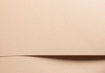 Monochrome background with overlapping beige and cream designer paper. Geometric shapes with