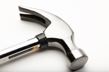 A close-up of a metallic hammer with a smooth handle and a shiny head. The hammer features a claw for pulling nails and is designed for construction tasks.