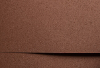 Fototapeta premium Premium designer paper in chocolate brown tones with pitted porous texture and spongy perforated