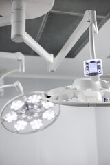 Close up view of powerful two white surgical lamps in modern white sterile operating room, close up. Medical equipment and HealthCare.  Banner design. High quality photo