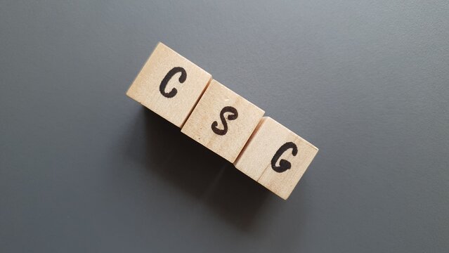CSG acronym made of wooden letter cubes on dark background. Contribution Sociale G&eacute;n&eacute;ralis&eacute;e (General Social Contribution, a tax funding social security)