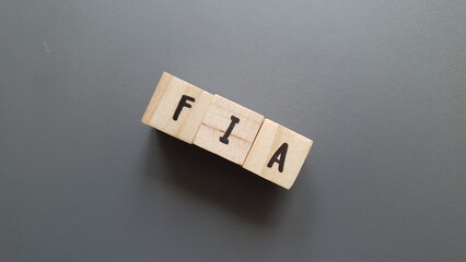 FIA acronym made of wooden letter cubes on dark background. Fonds d’Investissement Alternatif...