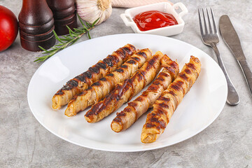 Grilled meat sausages wrapped bacon