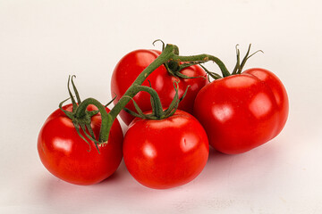 Ripe fresh tomato on the branch