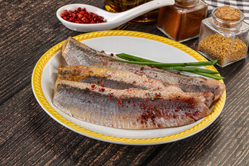 Salted marinated herring fillet with spices