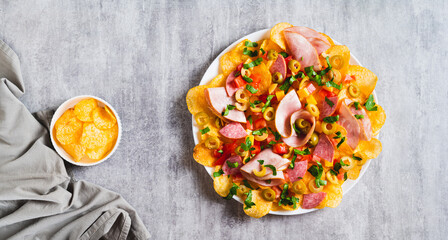 Snack trend Charcuterie nachos with potato chips on plate on table top view web banner