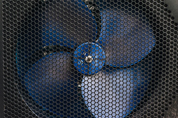 Background, texture of a fan propeller behind a metal mesh.