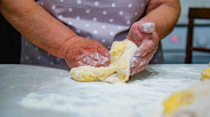 Granny baking buns in the kitchen. High quality photo