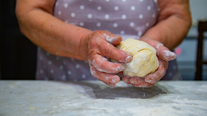 Granny baking buns in the kitchen. High quality photo