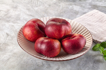Ripe sweet juicy flat nectarines heap