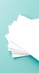 Stack of blank white envelopes on aqua background