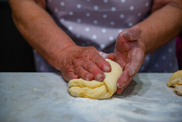 Granny baking buns in the kitchen. High quality photo
