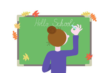 Woman, teacher writes on school board with chalk. Text, calligraphy inscription with chalk on the board. Chalkboard. Hello school, phrase. September 1, holiday. Autumn leaves.