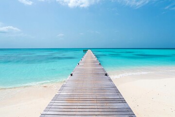 Obraz premium Wooden pier extending to turquoise ocean White sandy beach free beach background