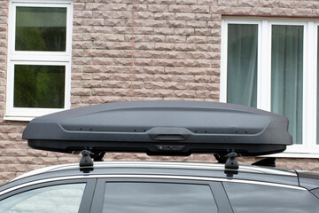 The trunk on the roof of a passenger car. Cargo transportation by car.