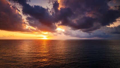 moody sunset sky over the ocean dark clouds illuminated with warm light create a captivating and atmospheric scene