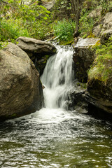 Stream of Water From Cow Creek Flows Over Boulders in Rocky Mountains