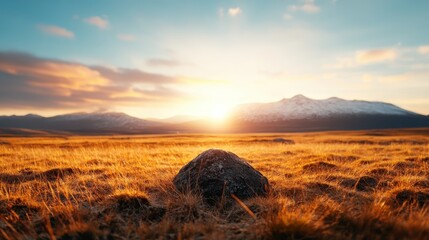 A breathtaking landscape at sunset, showcasing mountains bathed in warm hues, contrasting with the cool tones of the sky, perfect for travel or nature-related projects.