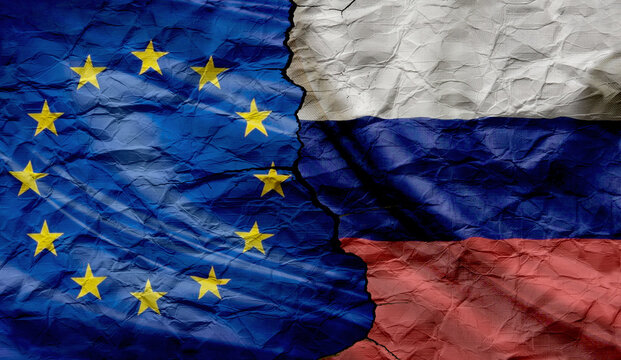 Flags of the European Union and Russia on crumpled and cracked paper. Concept of conflict between countries, tax policy and bilateral relations, peace and conflict between countries.