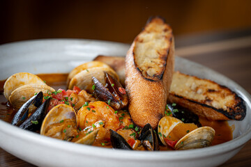 Cioppino - shrimp, scallop, clams, mussels, fish, orange peel, tomato, chardonnay, grilled baguette