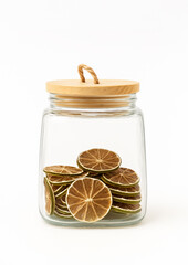 Glass jar with a wooden lid filled with dried lime slices. Minimalist composition on a white background, perfect for food preservation or citrus decoration themes.
