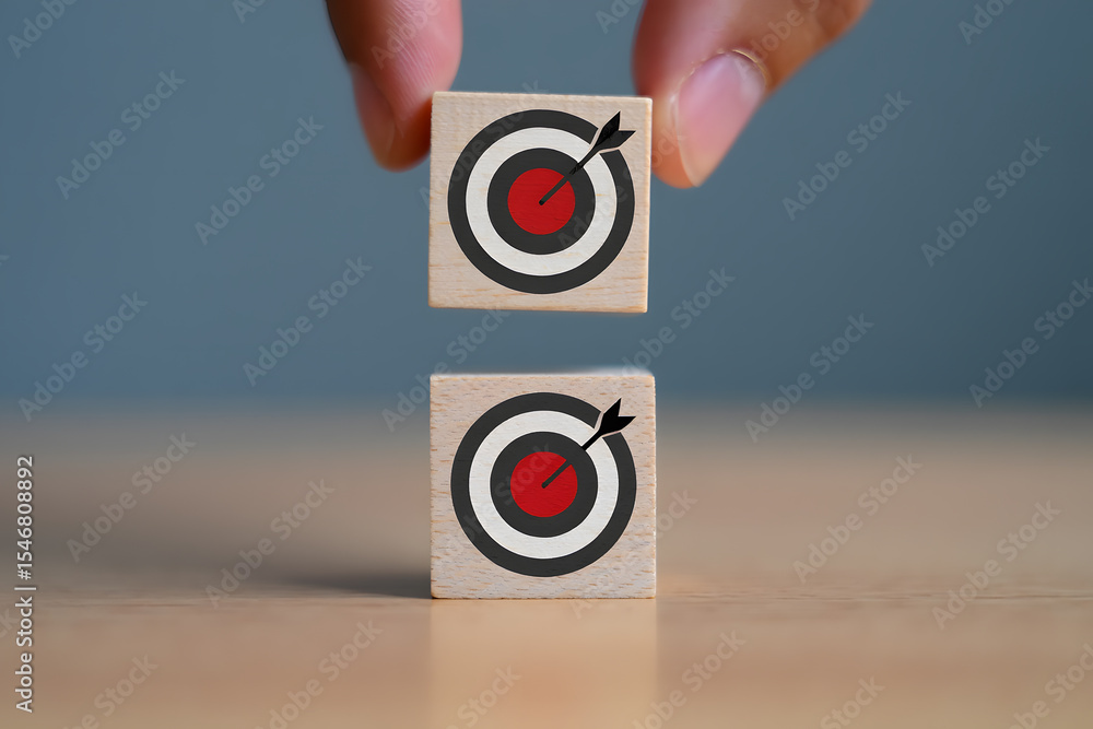 Poster stacking goals a conceptual image of wooden blocks with target symbols being stacked, representing b