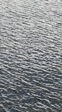 Ripples, waves on water, water texture (vertical)
