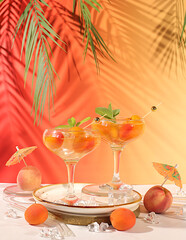 Alcoholic cocktail or punch, peach, apricot and mint berries on elegant background, minimalist...