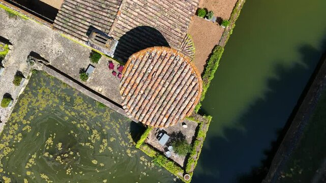 Aerial Shot of Circular Tiled Roof by Canal