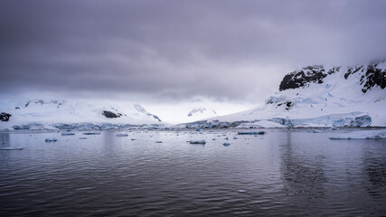 Beautiful paradise harbor in Antarctica under overcast sky