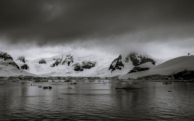 Beautiful paradise harbor in Antarctica under overcast sky