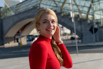 Woman in a red dress enjoying a sunny day in the city streets